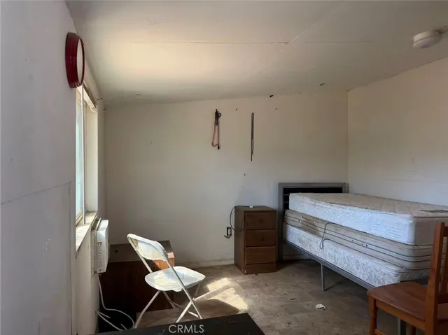 a bedroom with a bed and a chair