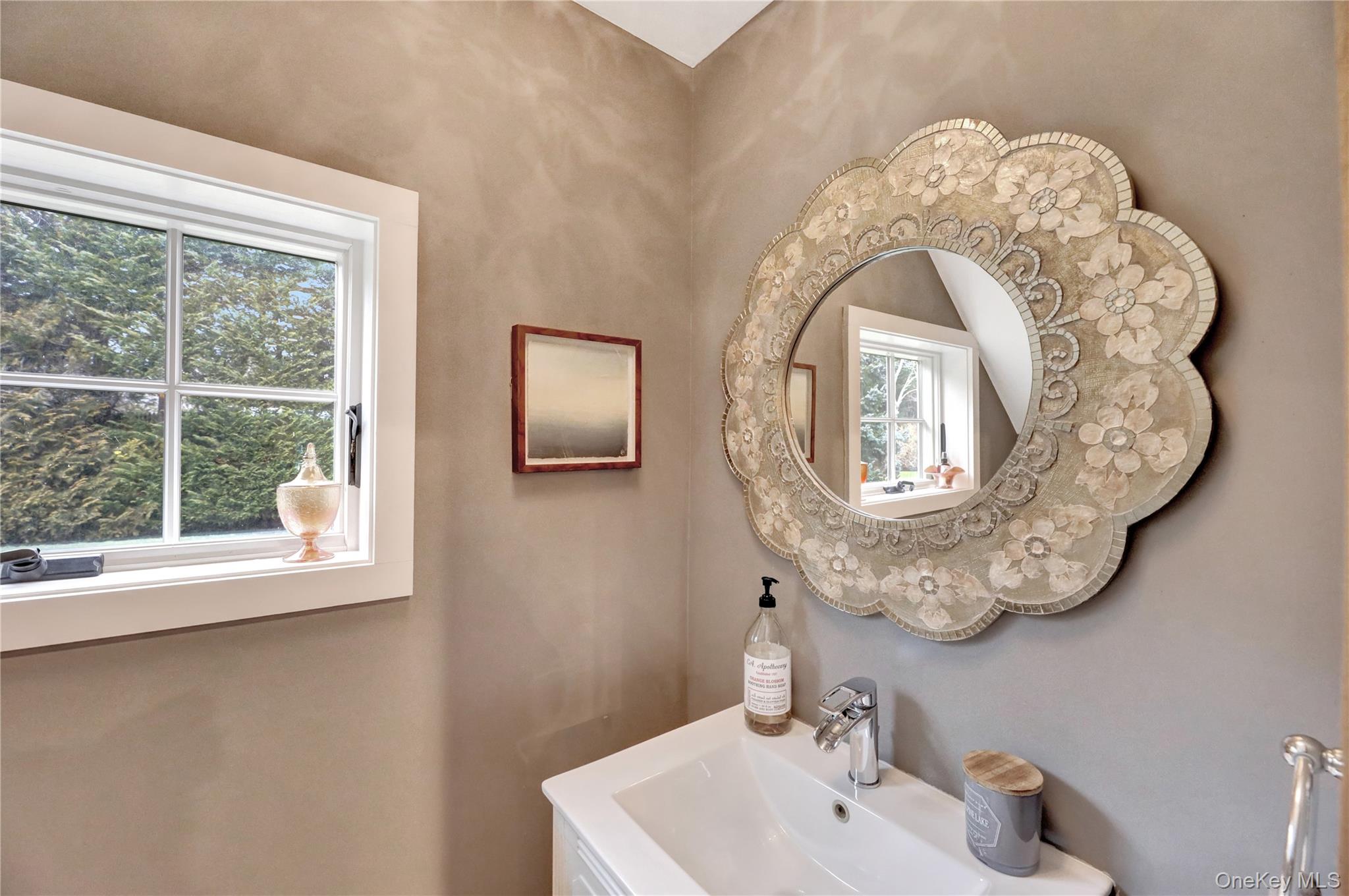 198 South Country Road Remsenburg, NY 11960 - Photo 36 of 49 a bathroom with a sink and a mirror