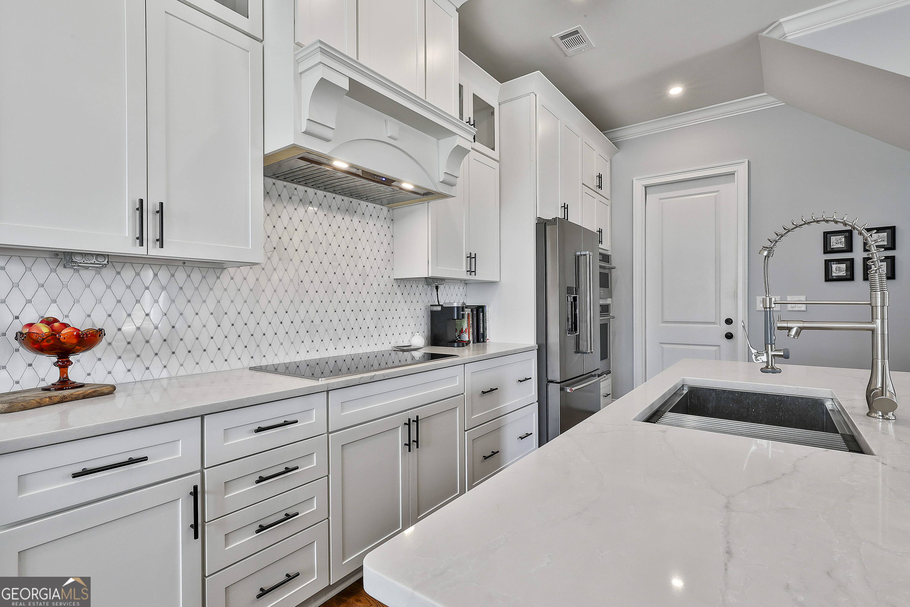 6 Casey Road Newnan, GA 30263 - Photo 16 of 46 a kitchen with stainless steel appliances kitchen island granite countertop a sink a refrigerator and cabinets