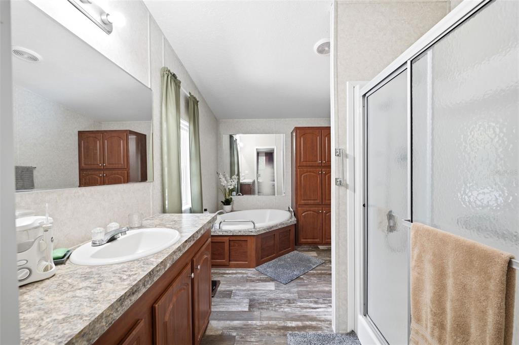 3183 Cedley Road Dade City, FL 33523 - Photo 14 of 48 a bathroom with a granite countertop sink and a mirror