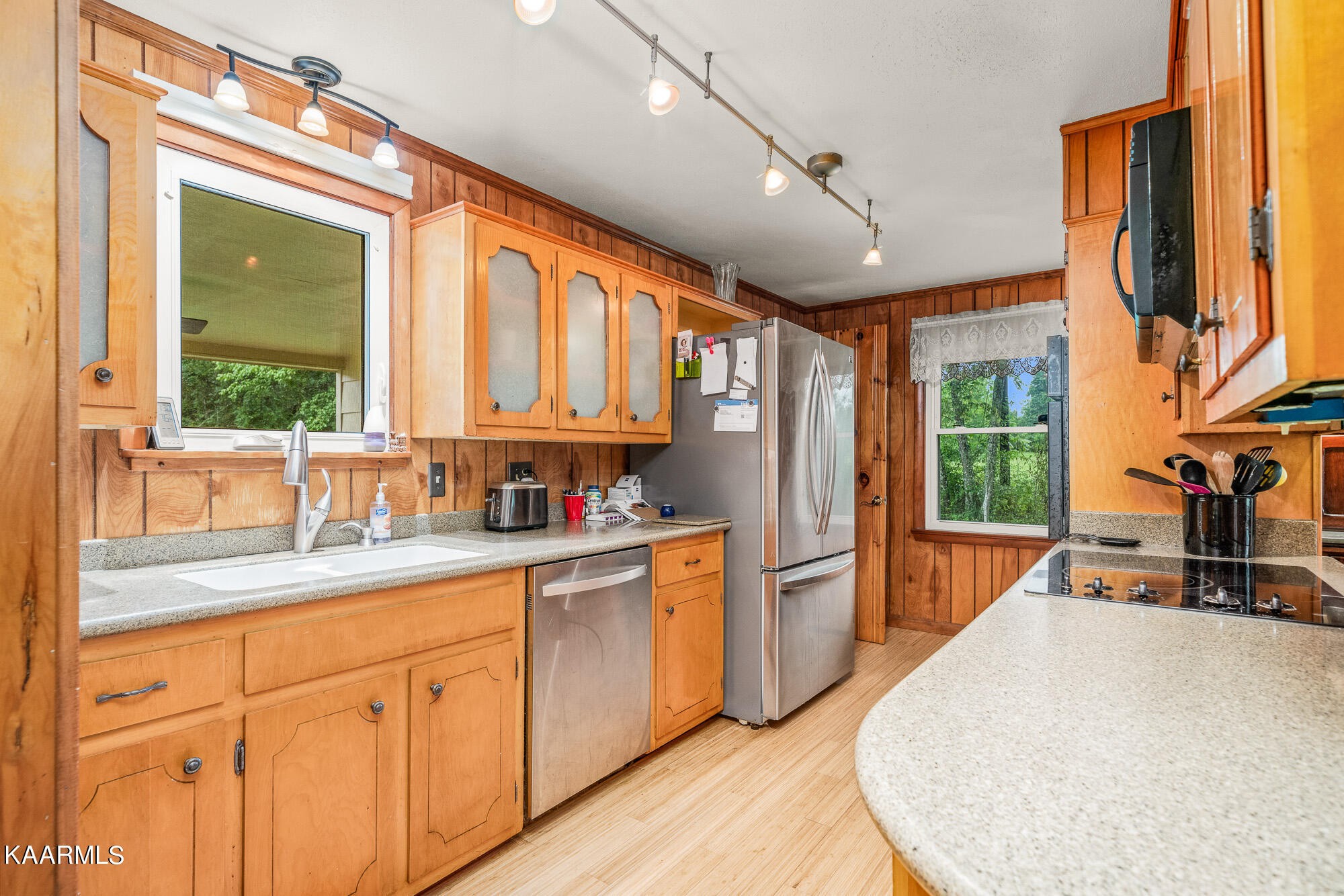 1360 Deep Draw Road Crossville, TN 38555 - Photo 11 of 40 a kitchen with stainless steel appliances granite countertop a refrigerator a sink dishwasher a stove and a dining table with wooden floor