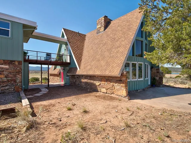 a view of a house with a snow in the yard
