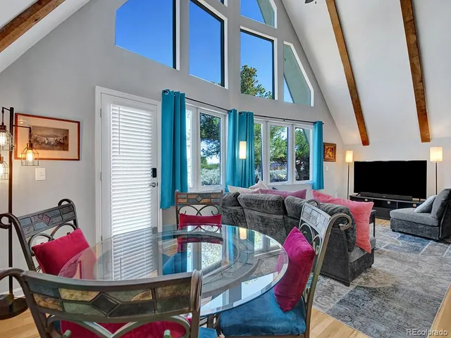 a living room with furniture and a floor to ceiling window