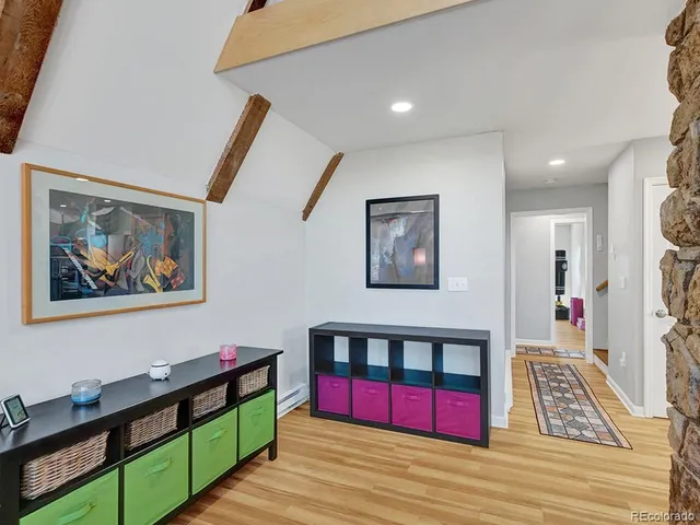 a view of hallway with mirror and furniture