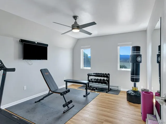 a view of a livingroom with workspace and a couch