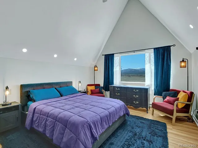 a bedroom with a bed and a dresser in it