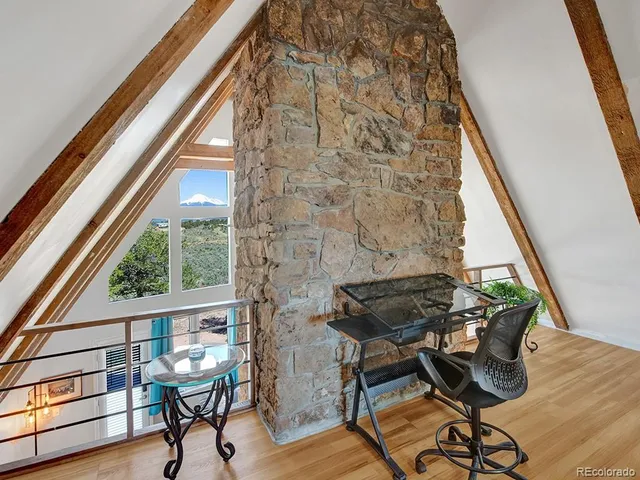 a view of a chairs and table in the balcony