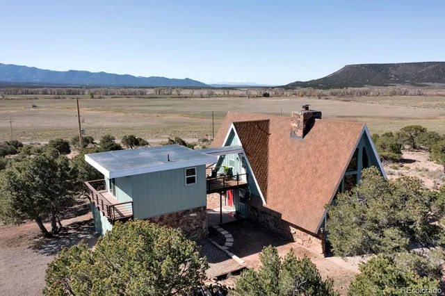 a view of a terrace with a table and chairs
