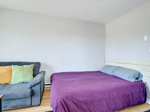 a kitchen with stainless steel appliances a dining table chairs and refrigerator