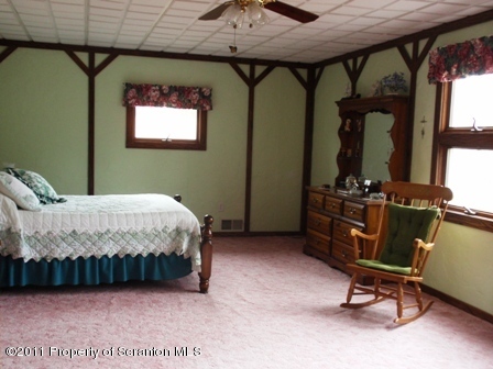 76 Indian Spring Road Tunkhannock, PA 18657 - Photo 12 of 18 a bedroom with a bed a desk and chair