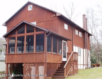 76 Indian Spring Road Tunkhannock, PA 18657 - Photo 4 of 18 a front view of a house with a yard
