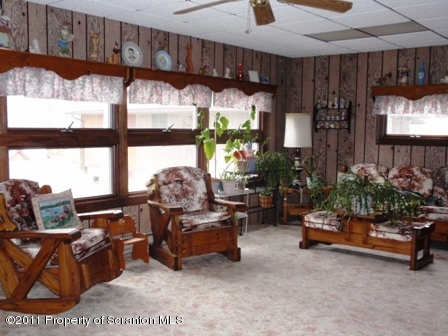 76 Indian Spring Road Tunkhannock, PA 18657 - Photo 6 of 18 a living room with furniture gym equipment and a chandelier