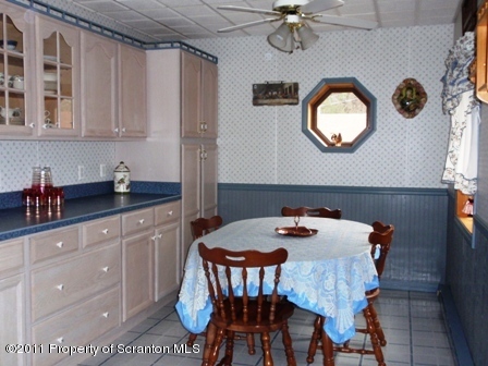 76 Indian Spring Road Tunkhannock, PA 18657 - Photo 9 of 18 a kitchen with a table chairs and a stove