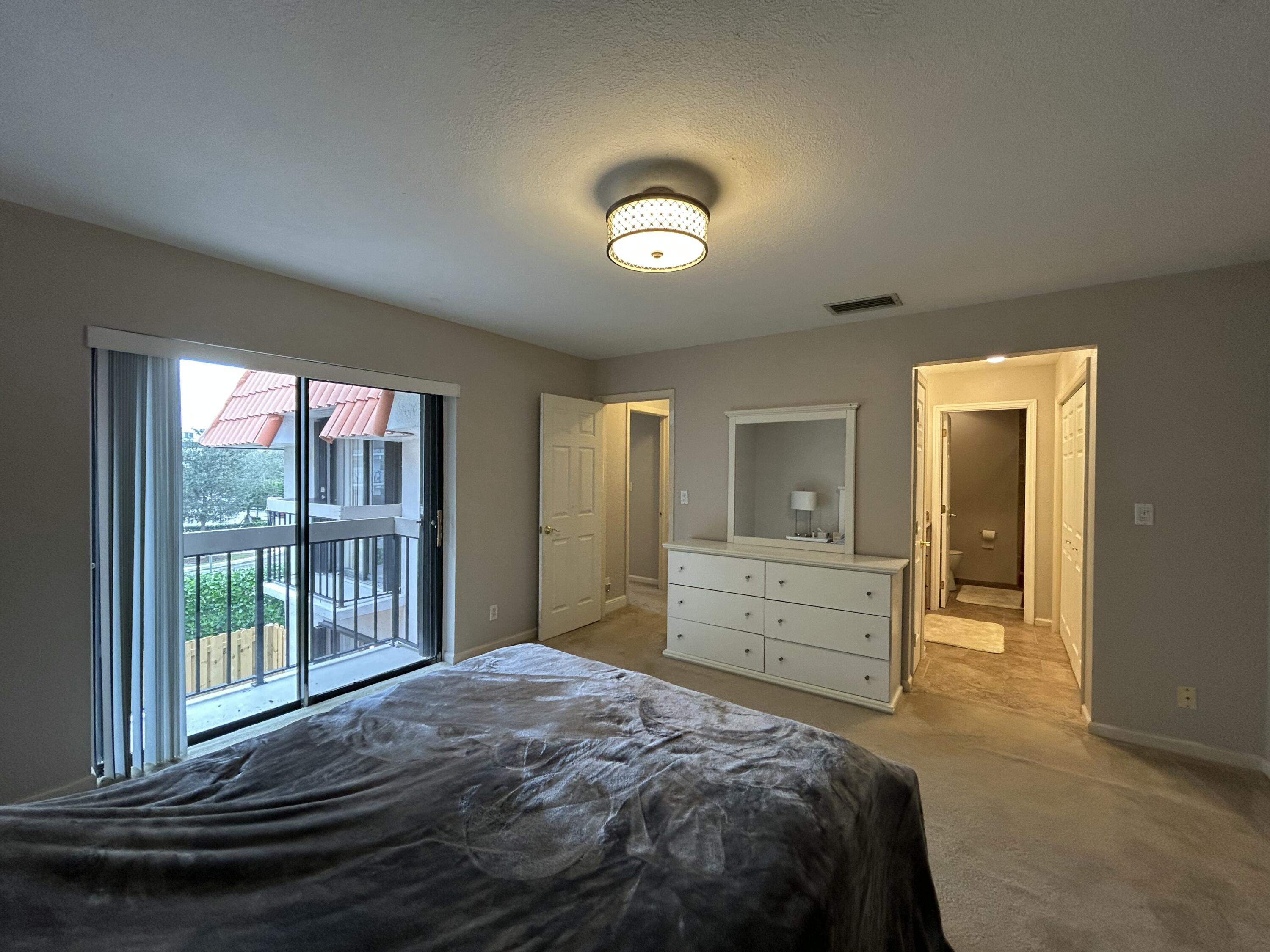 1251 South Federal Highway, Unit 1160 Boca Raton, FL 33432 - Photo 11 of 21 a bedroom with a bed and a dresser