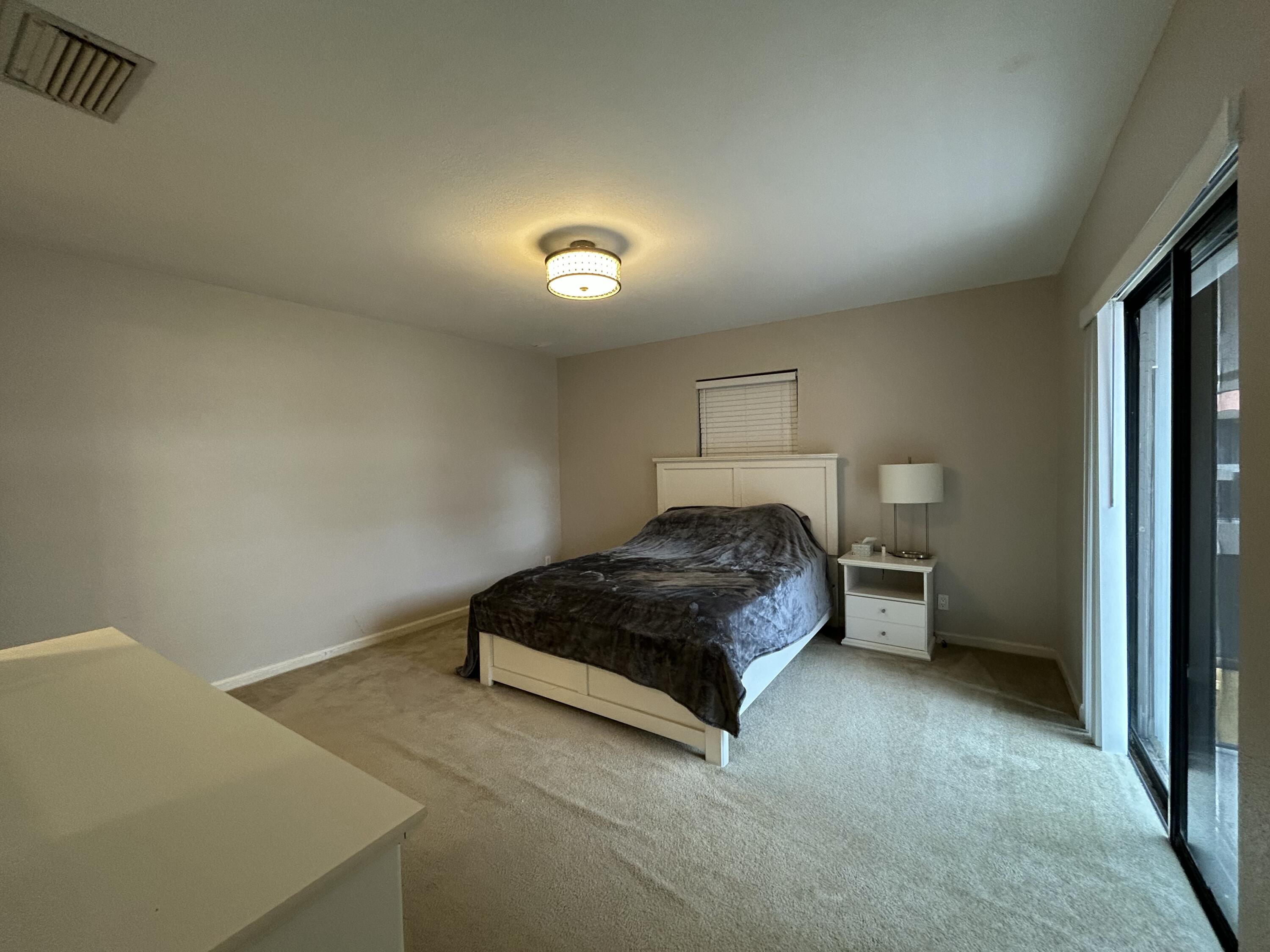 1251 South Federal Highway, Unit 1160 Boca Raton, FL 33432 - Photo 12 of 21 a spacious bedroom with a bed and a cabinets