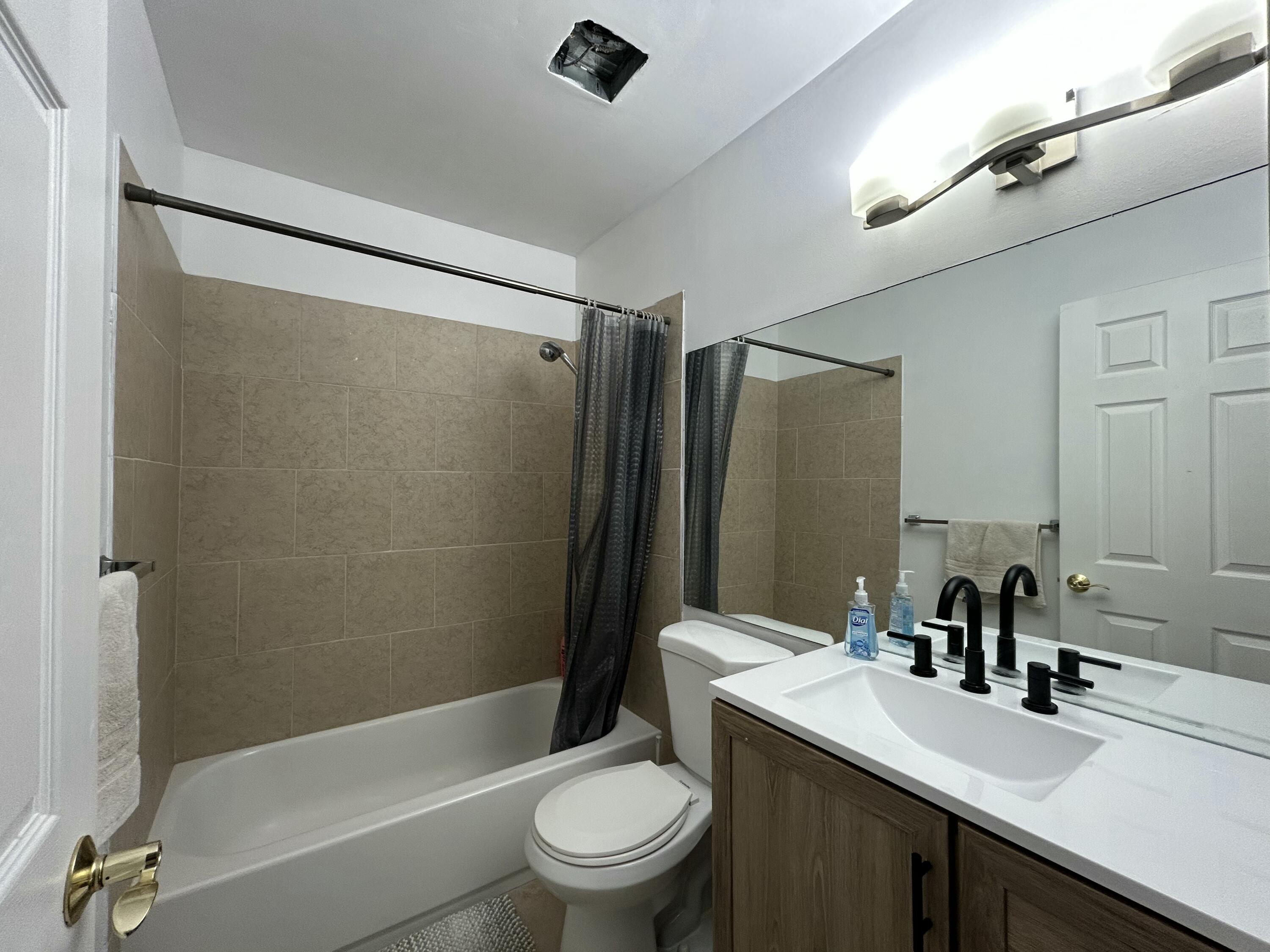 1251 South Federal Highway, Unit 1160 Boca Raton, FL 33432 - Photo 18 of 21 a bathroom with a sink a toilet a mirror and shower