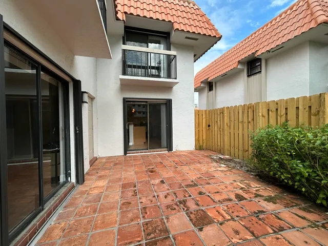 a view of a brick house with a large window