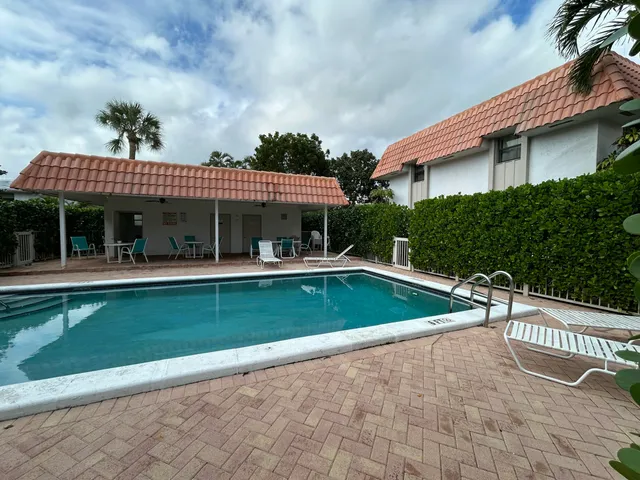a view of house with swimming pool outdoor seating