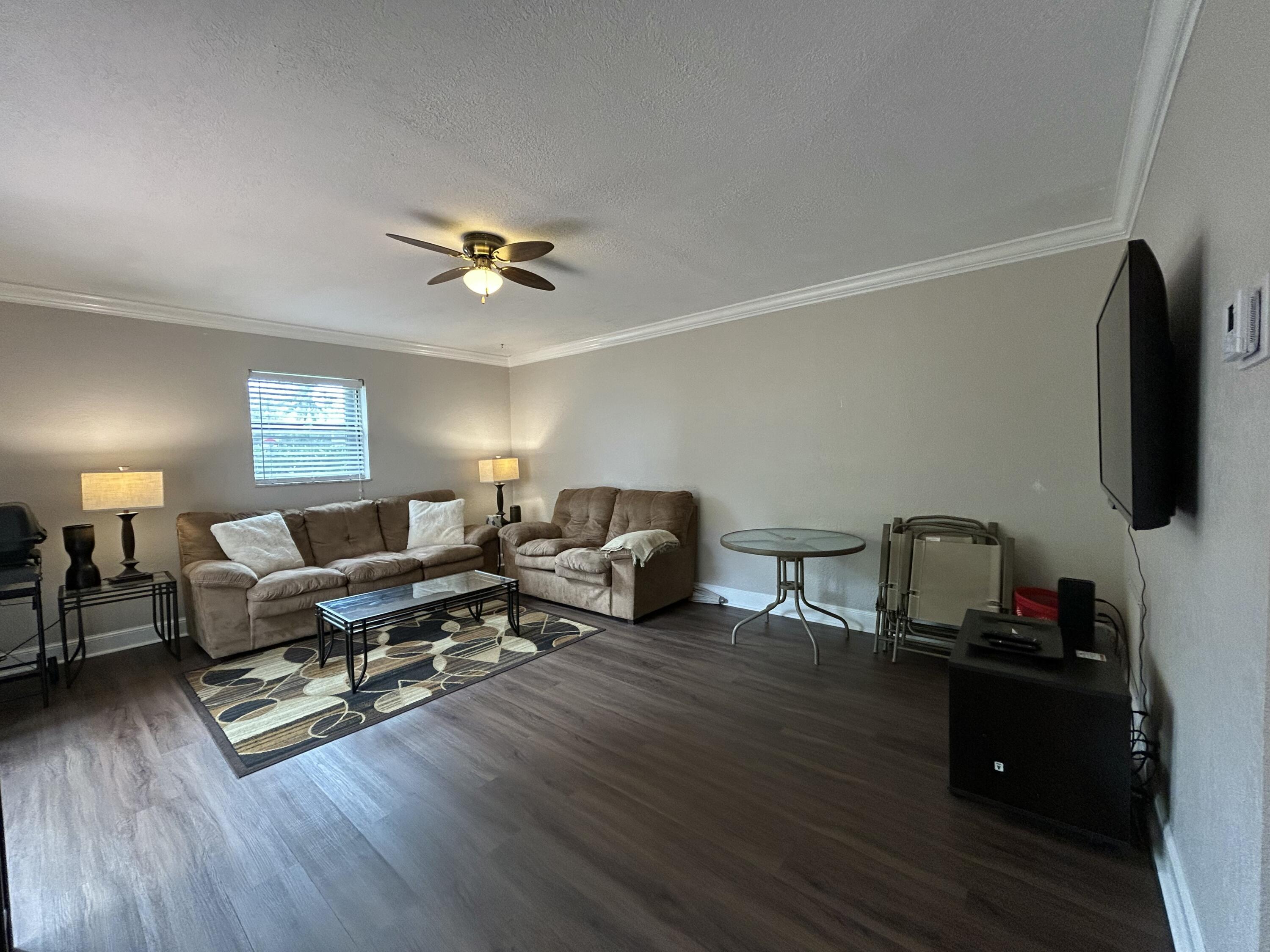 1251 South Federal Highway, Unit 1160 Boca Raton, FL 33432 - Photo 4 of 21 a living room with furniture flat screen tv and wooden floor