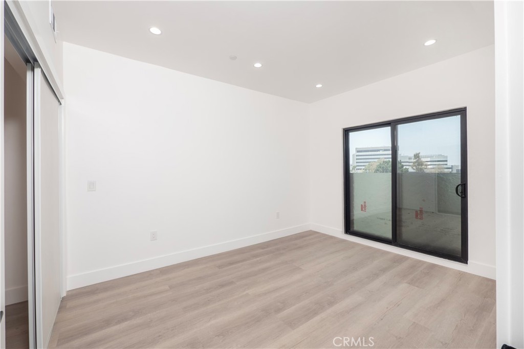1571 Ricardo Street, Unit 2 Los Angeles, CA 90033 - Photo 4 of 29 an empty room with wooden floor and windows