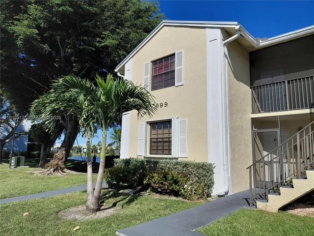 en view of a hallway with a chandelier fan