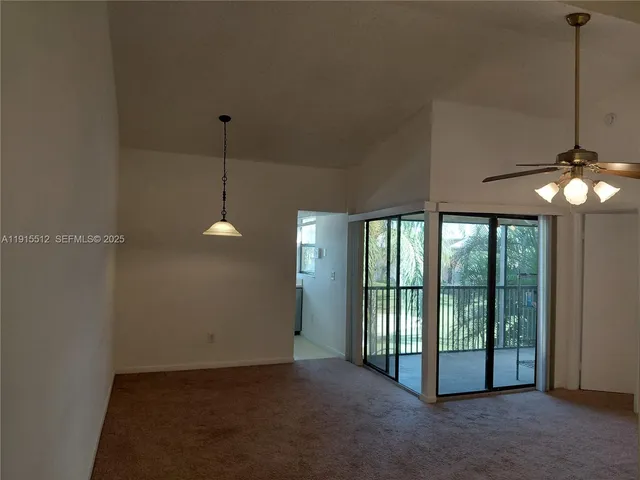 a kitchen with stainless steel appliances white cabinets and a refrigerator