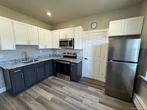 a kitchen with a refrigerator sink and microwave