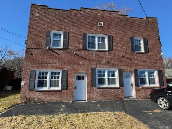 a front view of a house with parking area