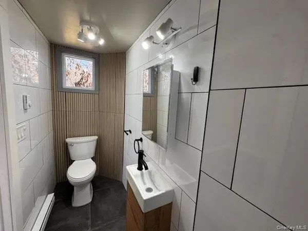 a bathroom with a toilet sink and shower