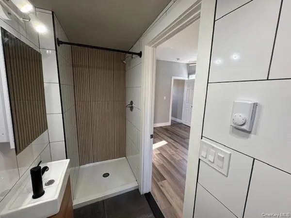 a bathroom with a shower and a tub