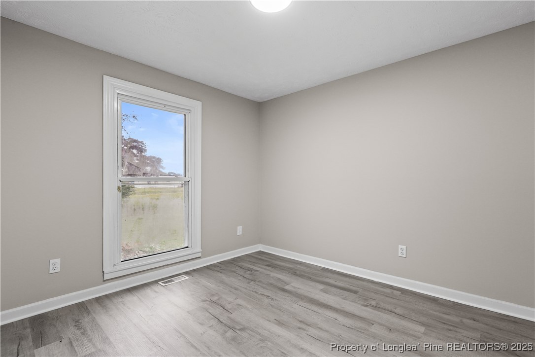 2302 Odom Road Hope Mills, NC 28348 - Photo 15 of 33 a view of an empty room with wooden floor and a window