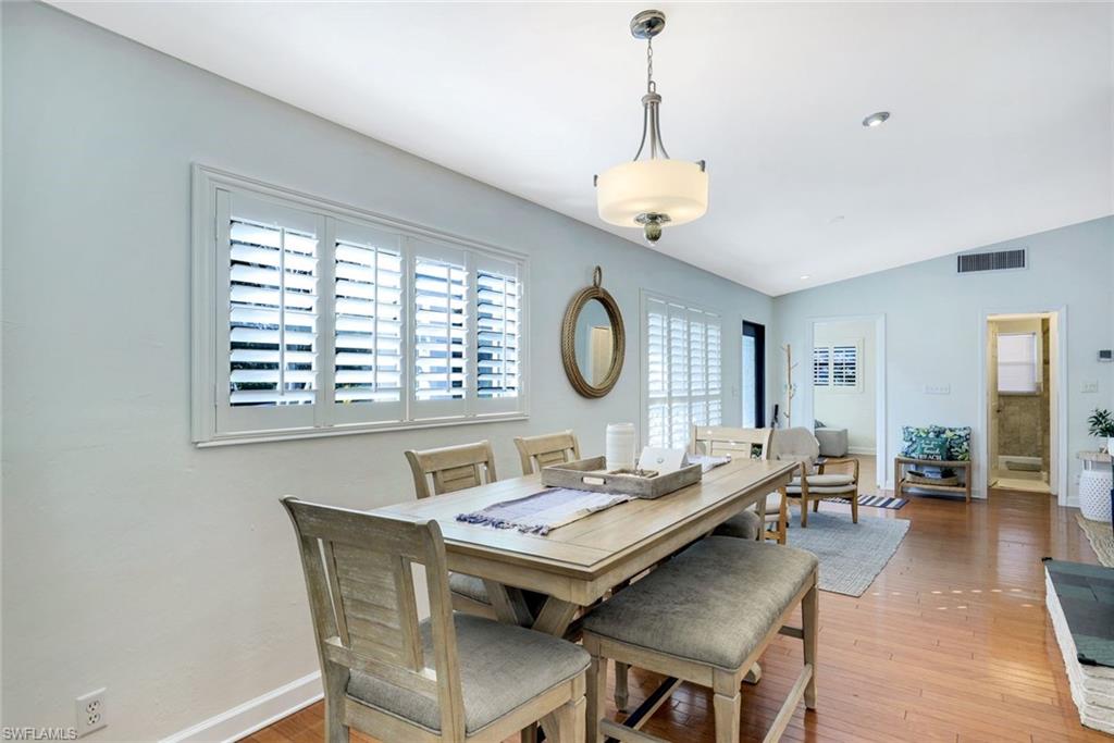 739 7th Avenue North Naples, FL 34102 - Photo 14 of 30 a view of a dining room with furniture window and wooden floor