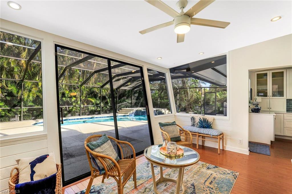 739 7th Avenue North Naples, FL 34102 - Photo 17 of 30 a living room with furniture and a floor to ceiling window