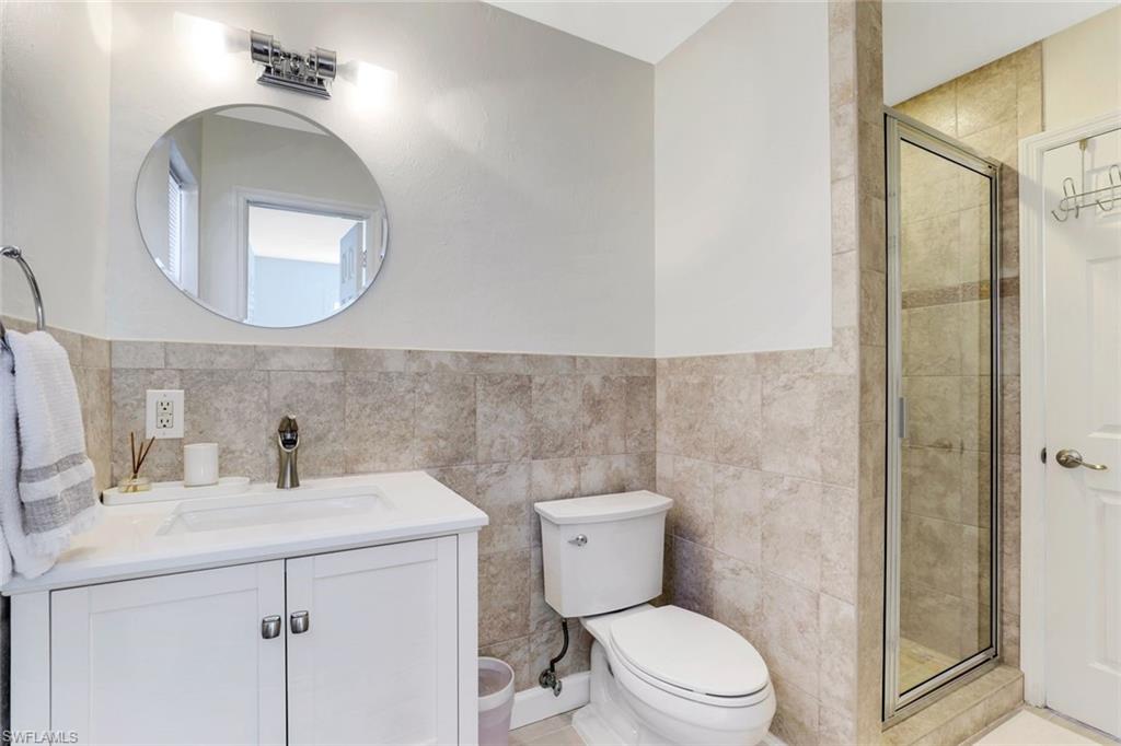 739 7th Avenue North Naples, FL 34102 - Photo 24 of 30 a bathroom with a toilet sink and mirror