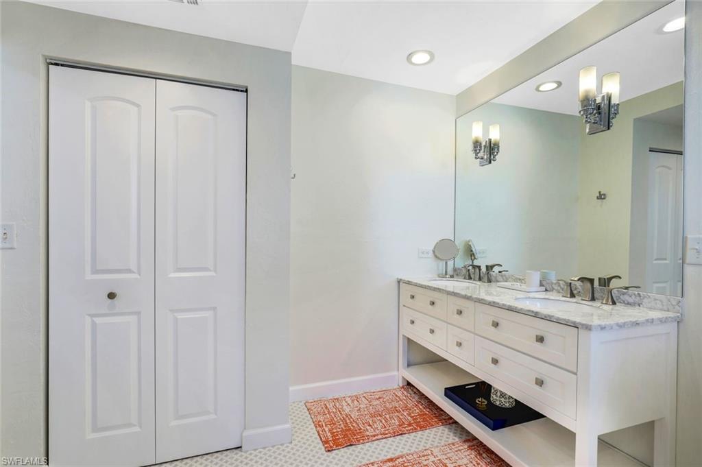 739 7th Avenue North Naples, FL 34102 - Photo 26 of 30 a bathroom with a double vanity sink a mirror and a