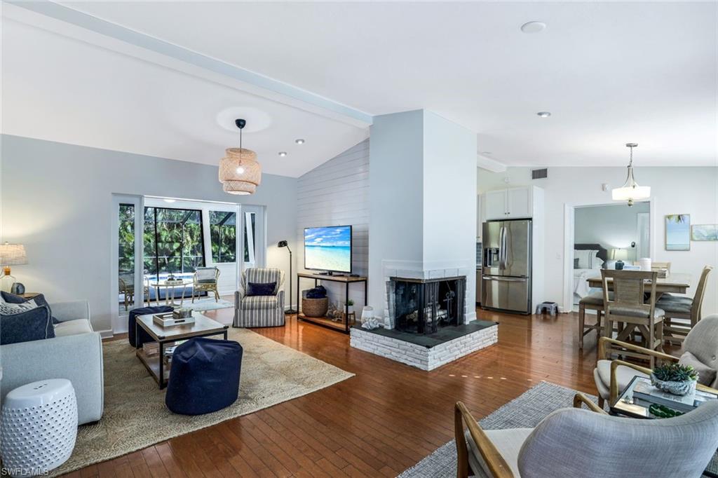 739 7th Avenue North Naples, FL 34102 - Photo 4 of 30 a living room with furniture fireplace and a large window