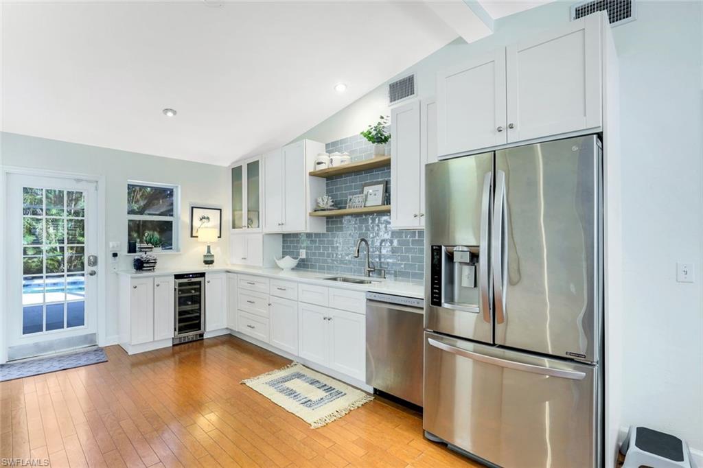 739 7th Avenue North Naples, FL 34102 - Photo 10 of 30 a kitchen with stainless steel appliances granite countertop a refrigerator sink and stove