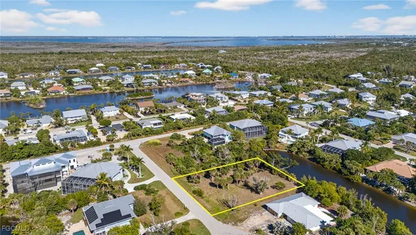 an aerial view of residential building and lake