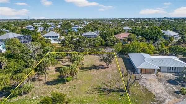 an aerial view of a house with a yard