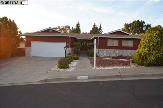 831 Laurel Court Rodeo, CA 94572 - Photo 1 of 1 a front view of a house with a yard and garage