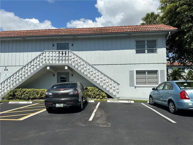 a view of a car parked in front of a house