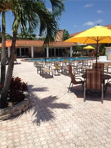 a view of a patio with a table and chairs