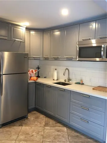 a kitchen with granite countertop stainless steel appliances and cabinets