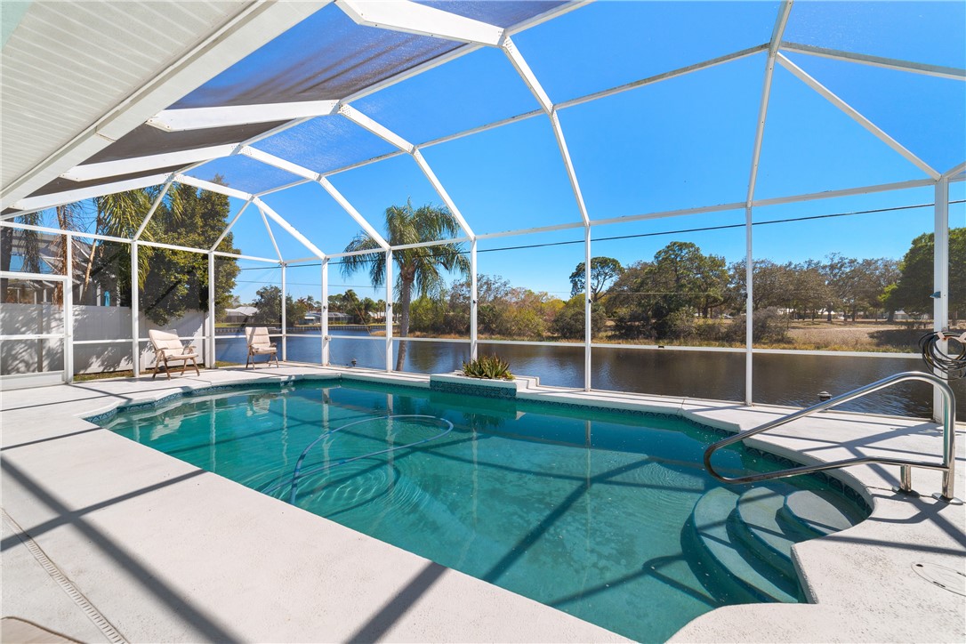 419 Ponoka Street Sebastian, FL 32958 - Photo 14 of 33 a view of a backyard with table and chairs under an umbrella