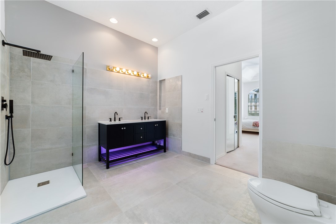 419 Ponoka Street Sebastian, FL 32958 - Photo 16 of 33 a bathroom with a shower a mirror and a sink