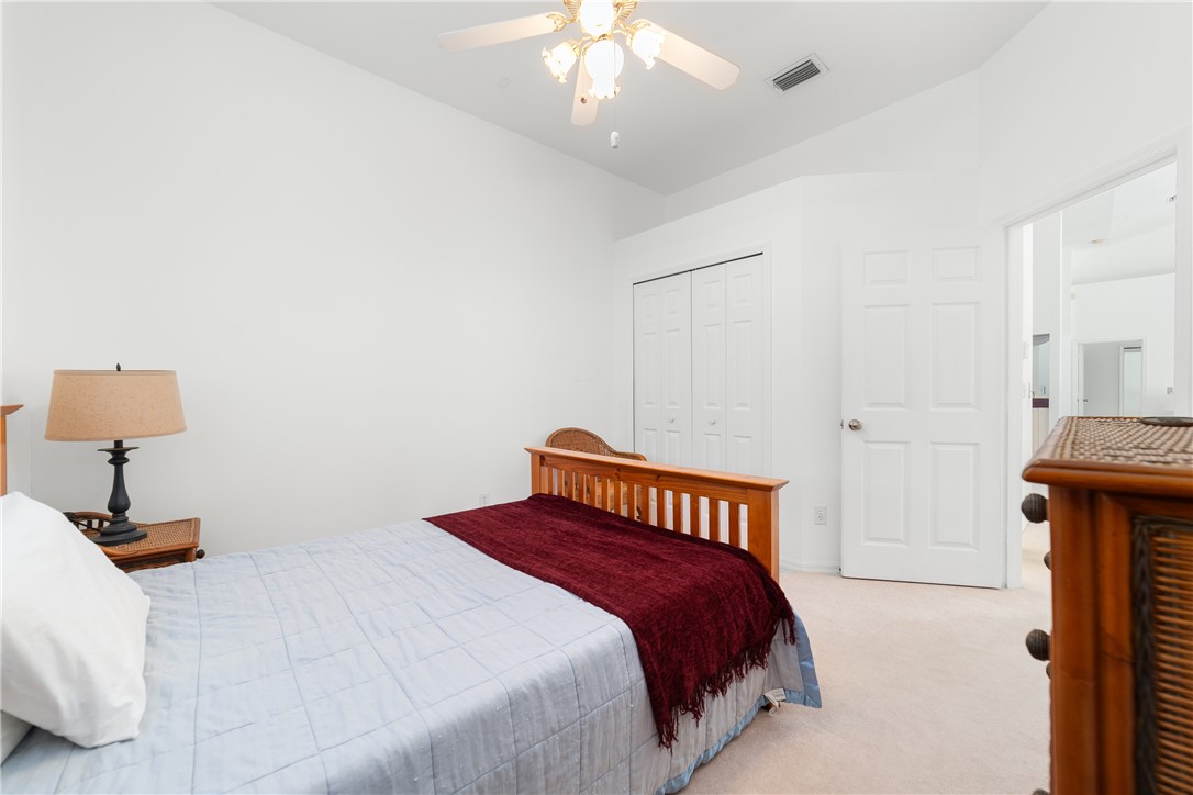 419 Ponoka Street Sebastian, FL 32958 - Photo 17 of 33 a bedroom with a bed and a lamp