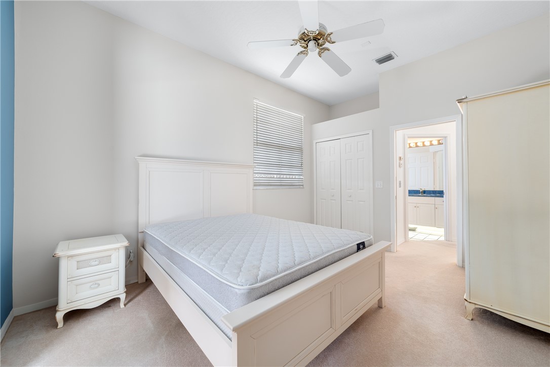 419 Ponoka Street Sebastian, FL 32958 - Photo 19 of 33 a room with a bed and a chandelier