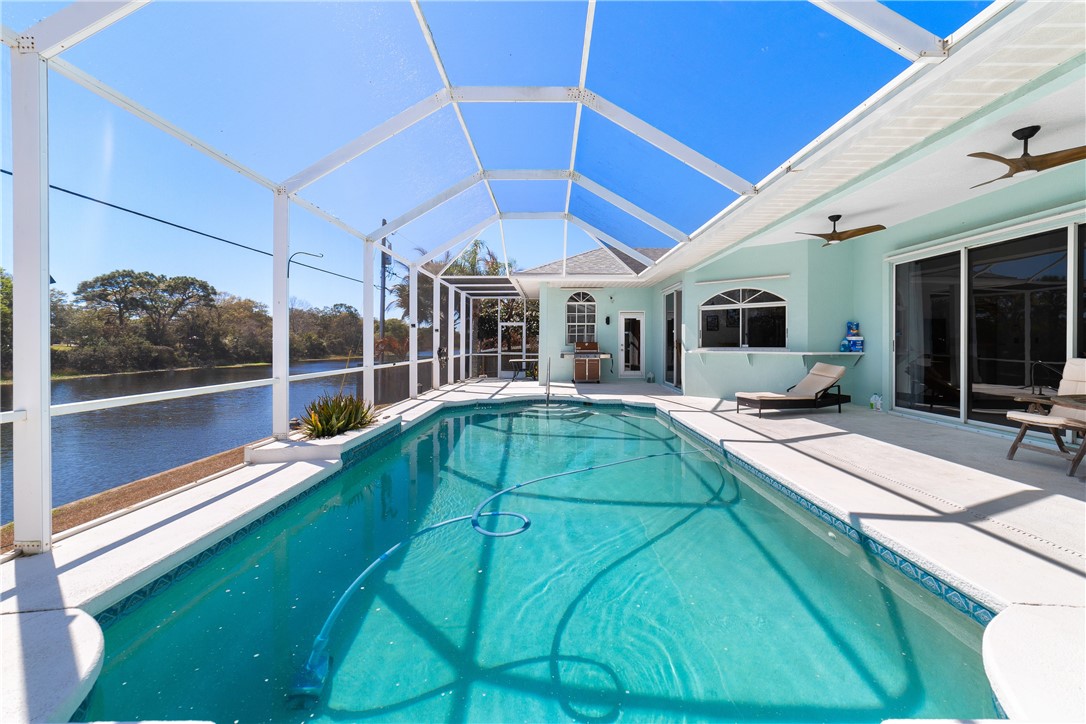 419 Ponoka Street Sebastian, FL 32958 - Photo 25 of 33 a view of a patio with table and chairs under an umbrella