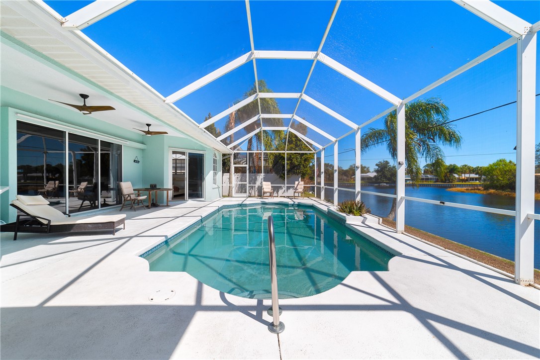 419 Ponoka Street Sebastian, FL 32958 - Photo 26 of 33 a swimming pool with outdoor seating and yard