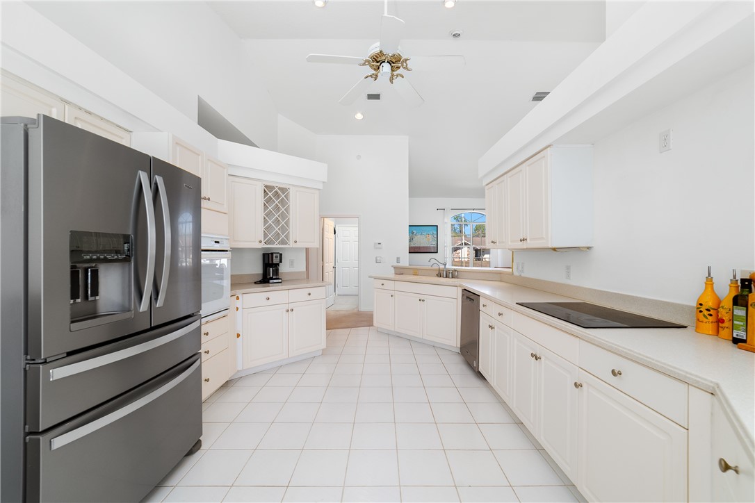 419 Ponoka Street Sebastian, FL 32958 - Photo 8 of 33 a large white kitchen with cabinets
